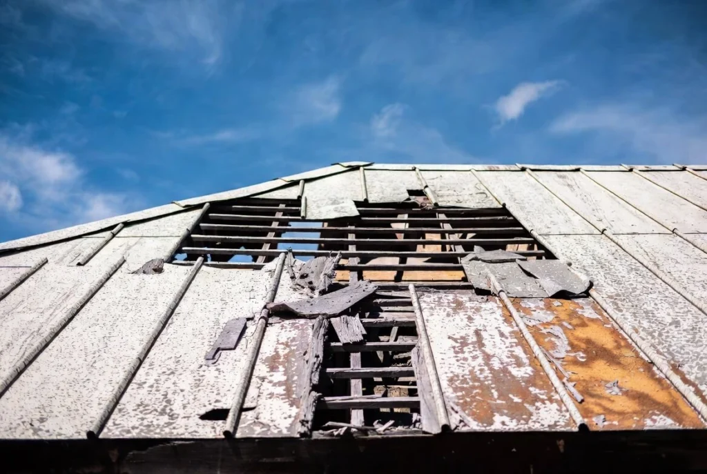Close-up view of damaged asbestos roof shingles