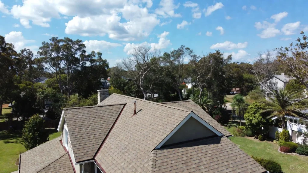 Close-up of a modern home featuring durable, dark gray residential rubber roofing shingles, providing a high-dimensional, weather-resistant finish.