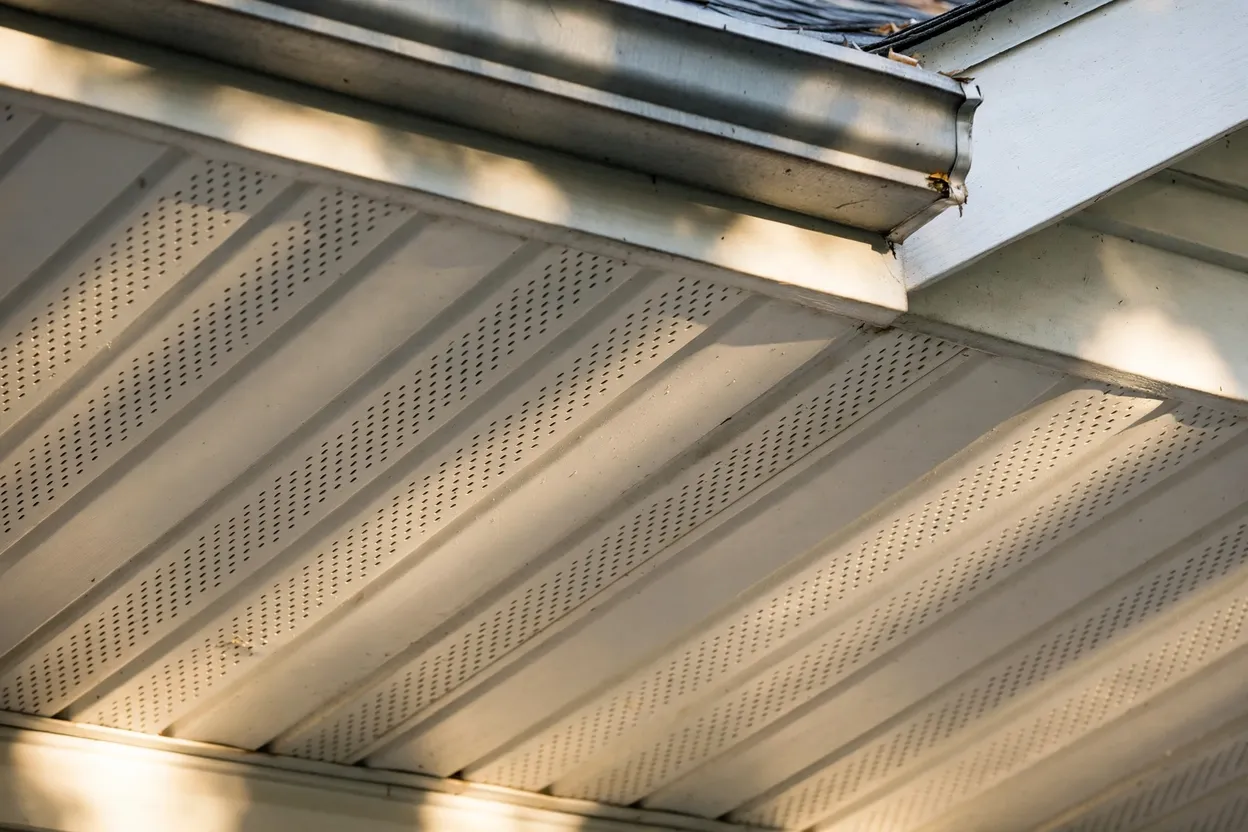 Vented roof soffit panels feeding air into the attic